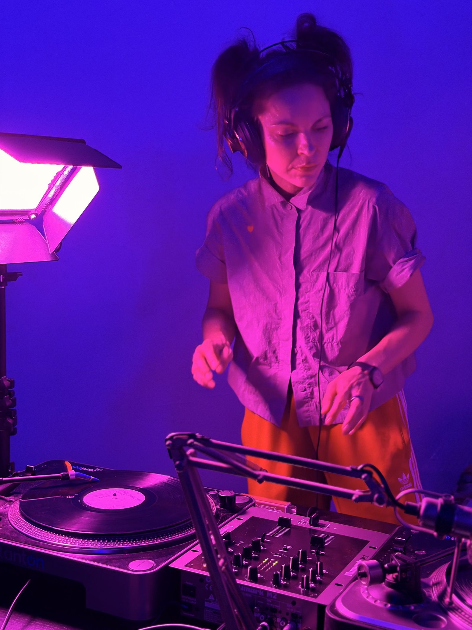 Ira Sagieva DJing on turntables under ultraviolet light
